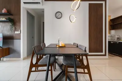 a dining room table with chairs and a clock on the wall at Kenwingston Platz 15MINS TO KLCC Modern Interior Boardgames A26 in Kuala Lumpur