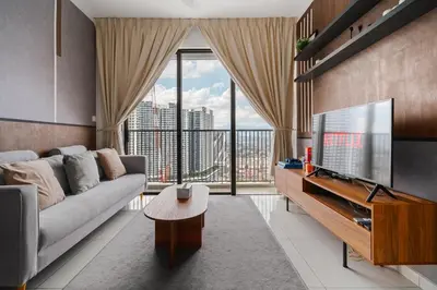 a living room with a couch and a large window at Kenwingston Platz Facing KLCC VIEW 15Mins To KLCC Fit 9Pax A24 in Kuala Lumpur