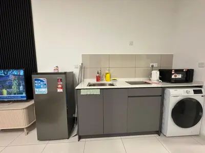 a kitchen with a sink and a washing machine at Majestic Residence KLCC By MYHOME in Kuala Lumpur