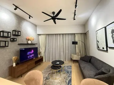 a living room with a couch and a ceiling fan at Star Residance KLCC By Nexus 24 in Kuala Lumpur