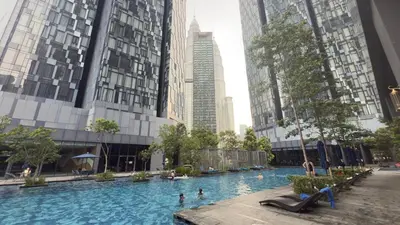 a swimming pool in a city with tall buildings at Star Residance KLCC By Nexus 24 in Kuala Lumpur