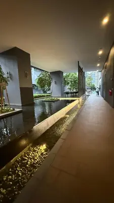 a building with a walkway next to a river at Star Residance KLCC in Kuala Lumpur