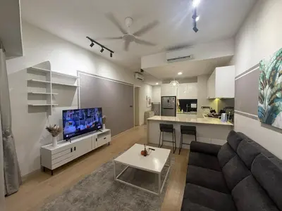 a living room with a couch and a tv at Star Residance KLCC in Kuala Lumpur