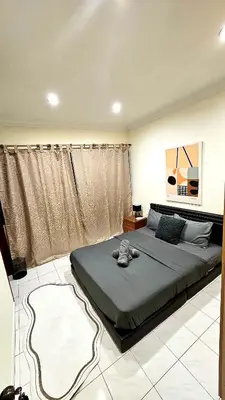 a bedroom with a large bed in a room at Cozy Private Room in Taman Desa Shared Bathroom in Kuala Lumpur