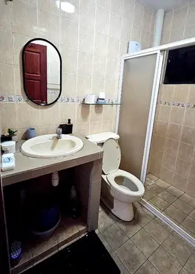 a bathroom with a toilet and a sink and a mirror at Cozy Private Room in Taman Desa Shared Bathroom in Kuala Lumpur