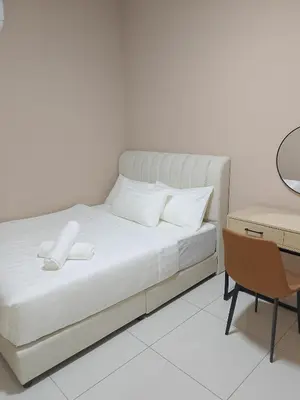 a white bedroom with a bed and a desk at majestic residence klcc rooftop pool in Kuala Lumpur