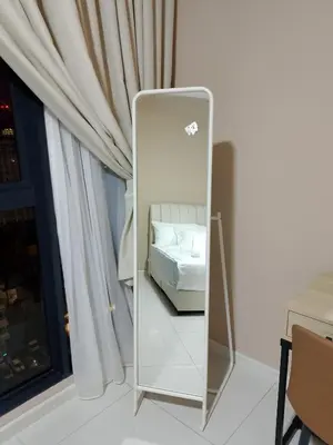a mirror in a room with a bed and a window at majestic residence klcc rooftop pool in Kuala Lumpur