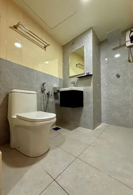 a bathroom with a toilet and a sink at Hotel Putra Hills in Kuala Lumpur