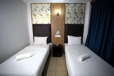 two beds in a small room at Hotel Putra Hills in Kuala Lumpur