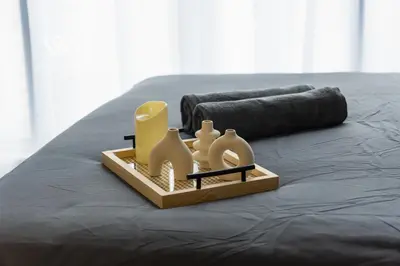 a tray of toys on top of a bed at Modern & Minimalist Studio at Majestic Residence KL in Kuala Lumpur