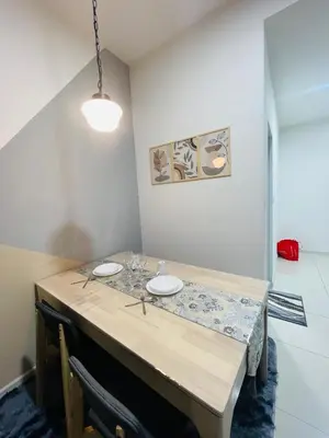 a dining room table with two white plates on it at Majestic Residence Kuala lumpur by Luxury in Kuala Lumpur