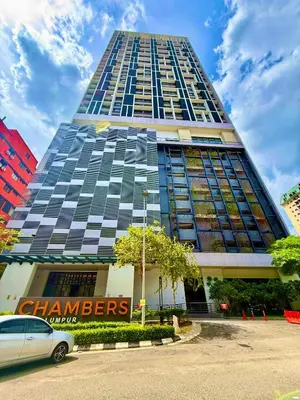 a tall building with a car parked in front of it at Klcc Suites 1 By Chambers RMS in Kuala Lumpur