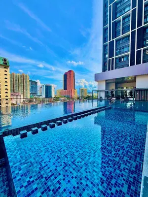 a large swimming pool with a city skyline in the background at Klcc Suites 1 By Chambers RMS in Kuala Lumpur
