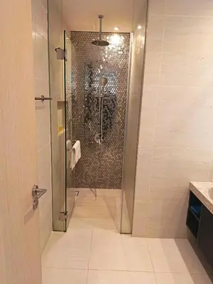 a shower with a glass door in a bathroom at Rahmans Care At Star Residence KLCC in Kuala Lumpur