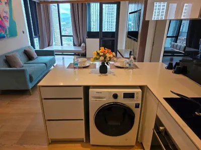 a kitchen with a counter with a washing machine at Rahmans Care At Star Residence KLCC in Kuala Lumpur