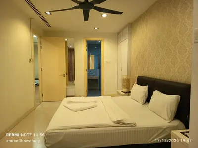 a bedroom with a bed with a ceiling fan at Rahmans Care At Star Residence KLCC in Kuala Lumpur