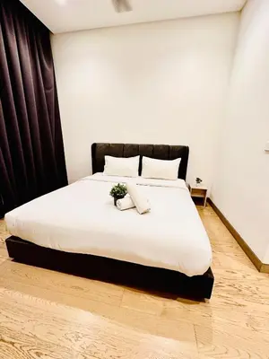 a bedroom with a large white bed with two pillows at Lucentia Residence At Bukit Bintang KLCC Pavilion in Kuala Lumpur