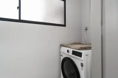 a washing machine in a room with a mirror at M Vertica KLCC View IKEA Velocity in Kuala Lumpur
