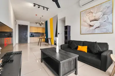 a living room with a black couch and a table at M Vertica KLCC View IKEA Velocity in Kuala Lumpur