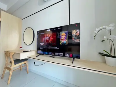 a large flat screen tv on a wall in a room at KLCC View Majestic Cozy Studio with Rooftop Pool in Kuala Lumpur