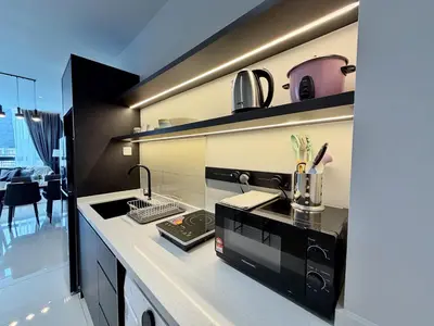 a kitchen with a sink and a stove top oven at Majestic Luxe 1BR Apt with KLCC View Rooftop Pool in Kuala Lumpur