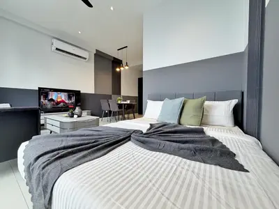 a bedroom with a large bed with a tv on it at Majestic Luxe 1BR Apt with KLCC View Rooftop Pool in Kuala Lumpur