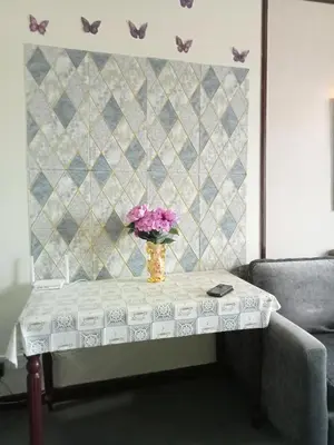 a table with a vase of flowers on top of it at Arba Suite Times Square KL in Kuala Lumpur