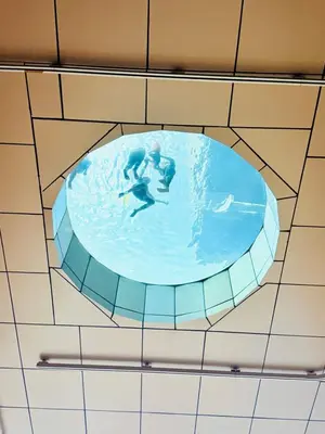 a painting of two people in a swimming pool at Studio Apartment Lucentia Residence in Kuala Lumpur