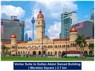 a large building with a clock tower in a city at Garden City of Lights Vortex Suites in Kuala Lumpur