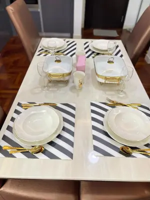 a table with plates and silverware on top of it at The Mews Klcc by Annie in Kuala Lumpur