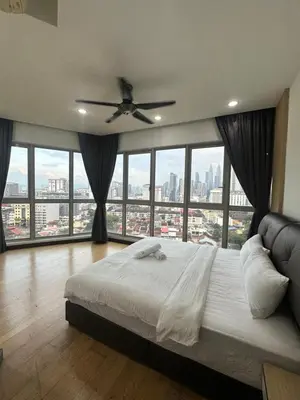 a bedroom with a large bed and large windows at regalia Panorama KLCC view in Kuala Lumpur