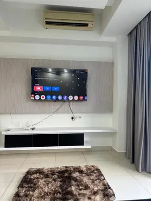 a living room with a flat screen tv on a wall at regalia Panorama KLCC view in Kuala Lumpur