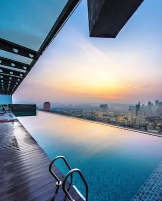 a swimming pool on top of a building with a city skyline at regalia Panorama KLCC view in Kuala Lumpur