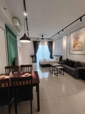 a living room with a couch and a table at CHAMBERS RESIDENCE KLCC By DELUXE HOME in Kuala Lumpur