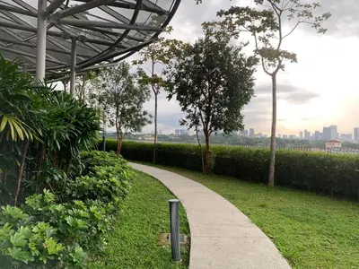 a walkway in a park next to a hedge at Homestay at Trion Kuala Lumpur in Kuala Lumpur
