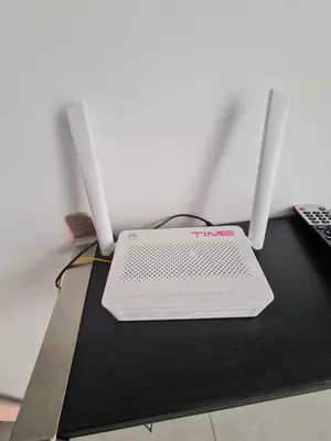 a laptop computer sitting on a table with two monitors at Stylish Studio Neu Suites 10 mins to KLCC in Kuala Lumpur