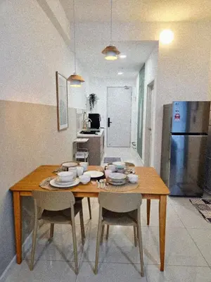 a kitchen with a wooden table with chairs and a refrigerator at KLCC View Pool & Gym 1 Bedroom Near LRT and Mall in Kuala Lumpur