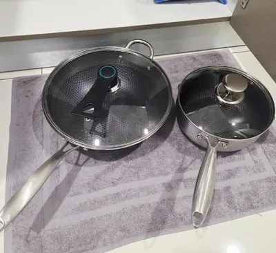 a pan and two spoons sitting on a counter at KLCC View Pool & Gym 1 Bedroom Near LRT and Mall in Kuala Lumpur