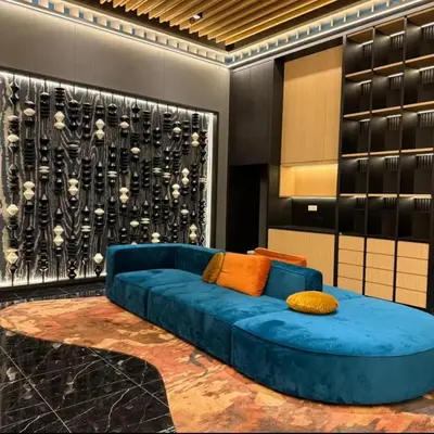 a blue couch in a room with a wall at KLCC View Pool & Gym 1 Bedroom Near LRT and Mall in Kuala Lumpur