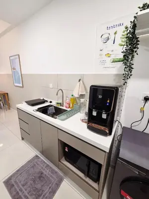 a kitchen with a counter top with a microwave at KLCC View Pool & Gym 1 Bedroom Near LRT and Mall in Kuala Lumpur