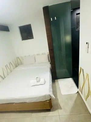 a bedroom with a bed with a towel on it at Day Cocoon In City Kuala lumpur in Kuala Lumpur