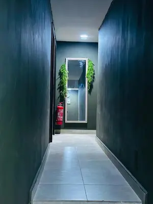 a hallway leading to a door with plants in it at Day Cocoon In City Kuala lumpur in Kuala Lumpur
