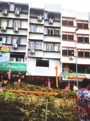 a tall building with flags in front of it at Day Cocoon In City Kuala lumpur in Kuala Lumpur