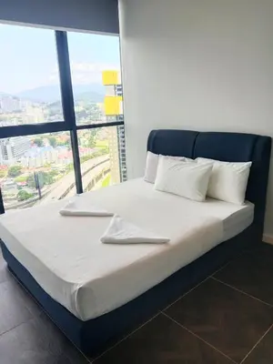 a bed in a room with a large window at SafeHouse At Scarletz Suite KLCC in Kuala Lumpur