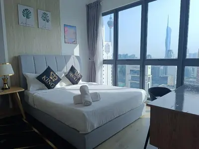 a bedroom with a large bed and a large window at The Luxe Colony By Kuala Lumpur Homestay in Kuala Lumpur
