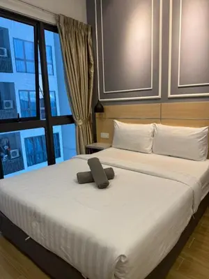a large white bed with a stuffed animal on it at The Luxe Colony By Kuala Lumpur Homestay in Kuala Lumpur