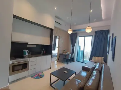 a living room with a couch and a large screen at The Luxe Colony By Kuala Lumpur Homestay in Kuala Lumpur