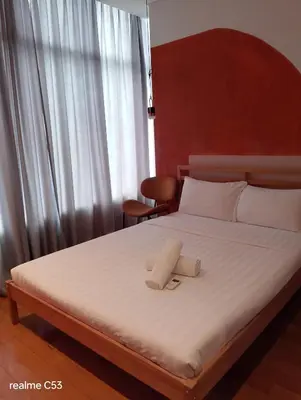 a bed with a pillow on top of it at Sky suites klcc stay Comfortable in Kuala Lumpur