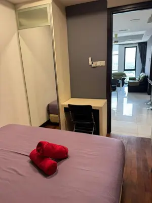 a red pillow sitting on a bed in a room at Casa Residency RH Homes in Kuala Lumpur