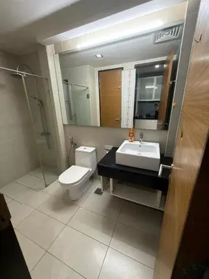 a bathroom with a toilet and a sink and a mirror at Casa Residency RH Homes in Kuala Lumpur